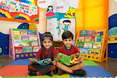 Children reading books together in classroom